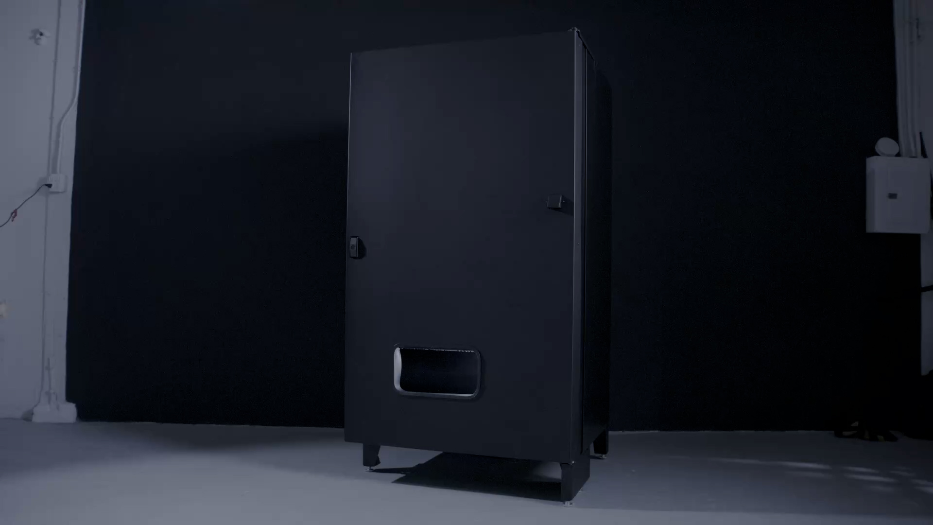 The DispenseGo machine, a black steel cabinet with a single dispense port